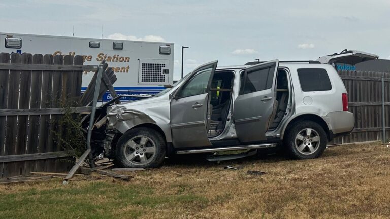 Driver sent to hospital after crashing into fence