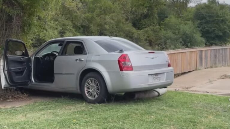 Man arrested after crashing car into fence