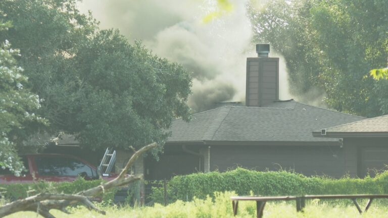 Multiple agencies battle large house fire on FM 974 in Brazos County